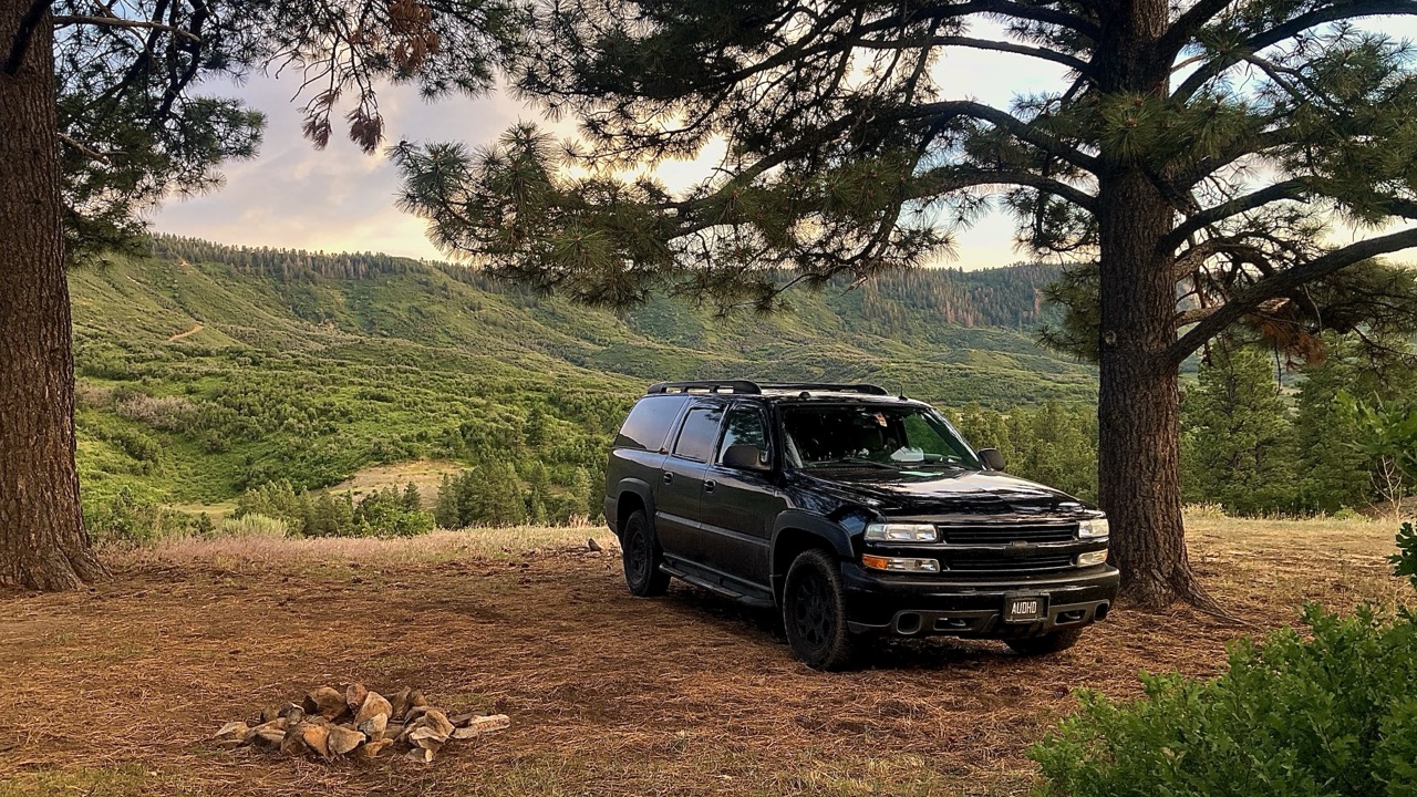 Horizon, a black 2004 Chevrolet Suburban Z71, parked in the mountains